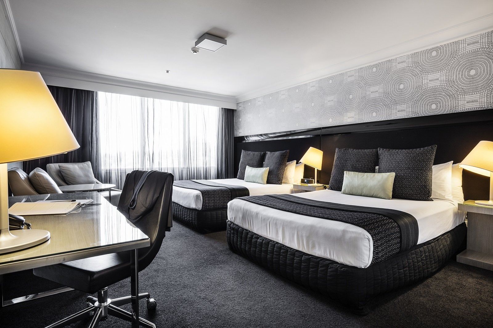 Two queen beds, work desk & loungers at Pullman & Mercure Brisbane King George Square