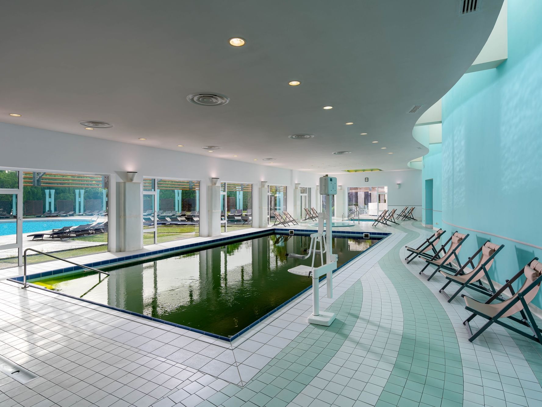 Swimming pool with chairs in Indoor Treatment Pool at Ana Hotels Europa Eforie Nord