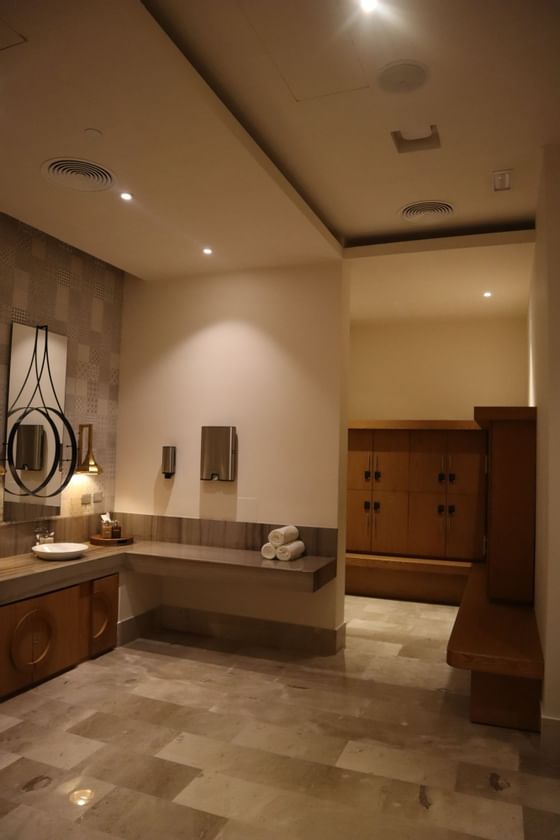 Spa treatment room at Haven Riviera Cancun with amenities and lockers.