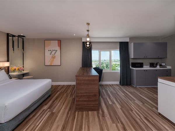 Separated bedroom and kitchen area in a room at Warwick Hotel Al Jubail