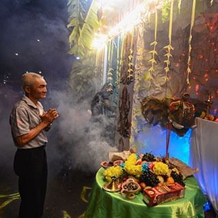 An old man is praying to Indian gods