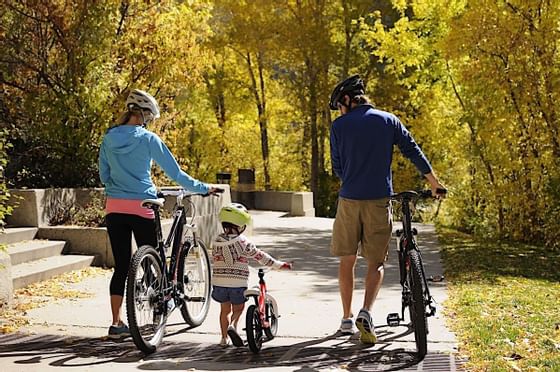 Family walking bikes in Glenwood Canyon in Fall