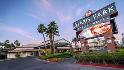 Low angle view of the hotel sign board & entrance at Alexis Park Resort