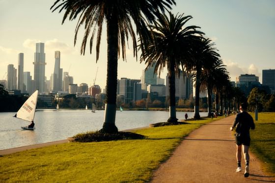 A man jogging at Albert Park Lake near The Kinson