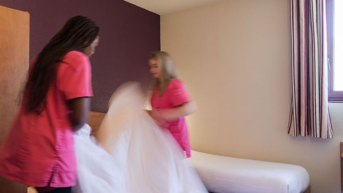 Maids making room beds at Hotel costieres