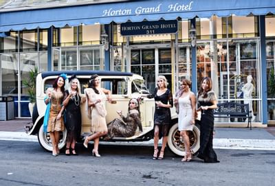 Vintage car in front of Horton Grand Hotel with girls