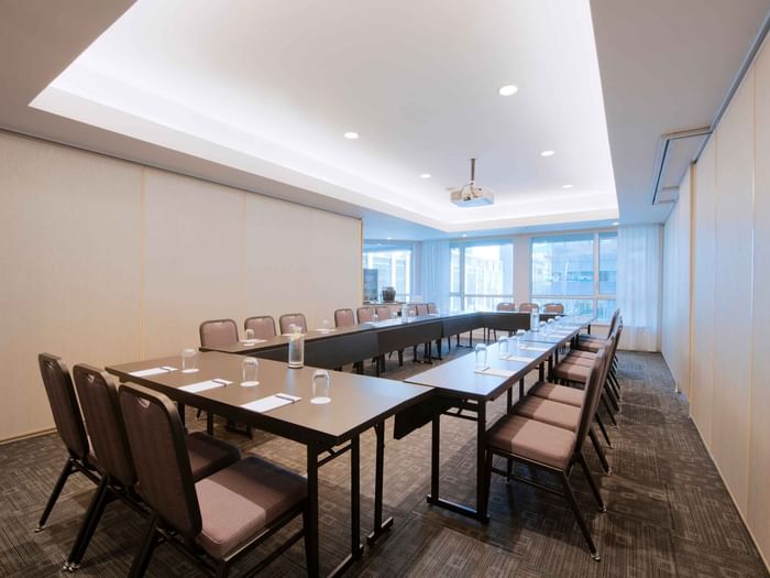 U-shaped table setup with dark chairs by the window in Salon René-Lévesque A at Warwick Le Crystal Montreal