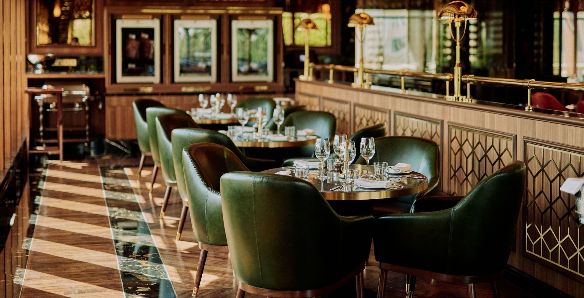 Elegant dining restaurant at Sunway Hotel Pyramid, featuring plush green chairs and polished wooden accents