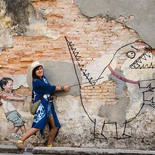 penang mural of little boy with pet dinosaur