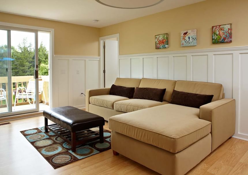 Lounge with plush seating by the window and wooden floors in Max Villas at Breezeway Boutique Hotel