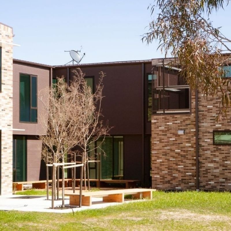 La Trobe University - McFarlane's Hill Residences with outdoor seating and green lawn.