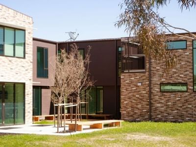 La Trobe University - McFarlane's Hill Residences with outdoor seating and green lawn.