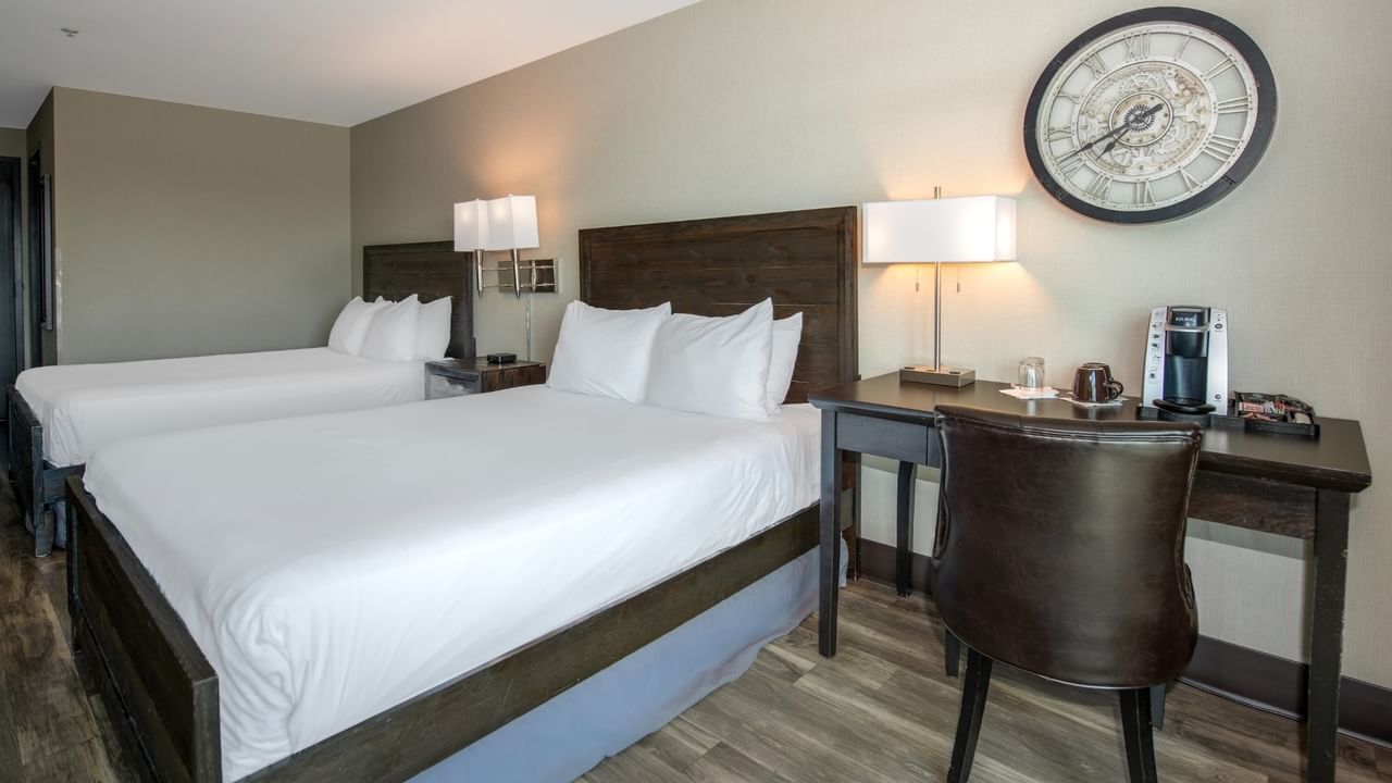 Coast Two Queens with two queen beds, a desk with a coffee maker, and a chair at Coast Lonsdale Quay Hotel