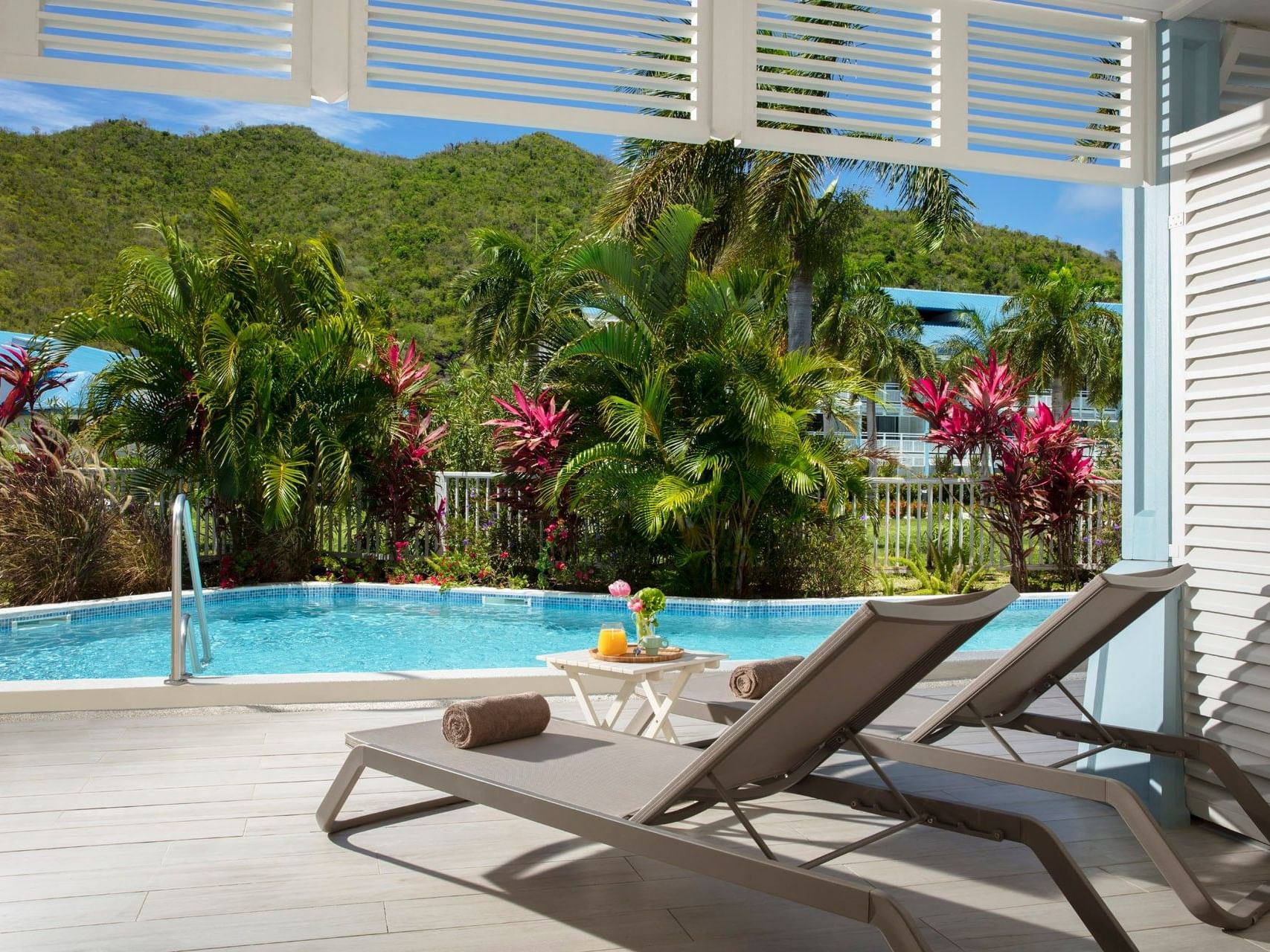 Two cozy sun loungers by the pool at King Bed Suite with Swim-Out Pool Access in Saint Martin Beach Resort & Spa
