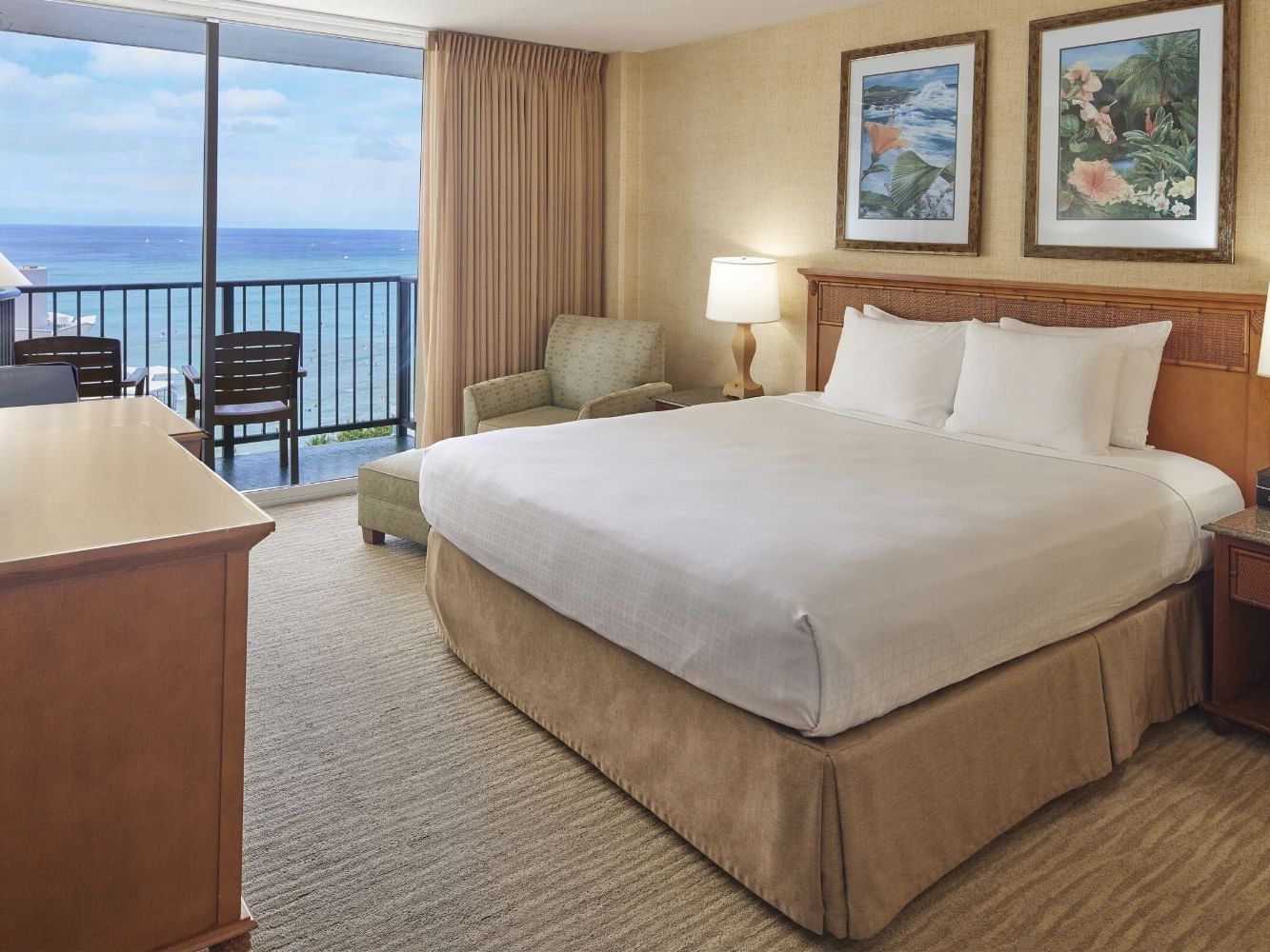 King-size bed with a single sofa & the balcony view in Partial Ocean View at Waikiki Resort Hotel