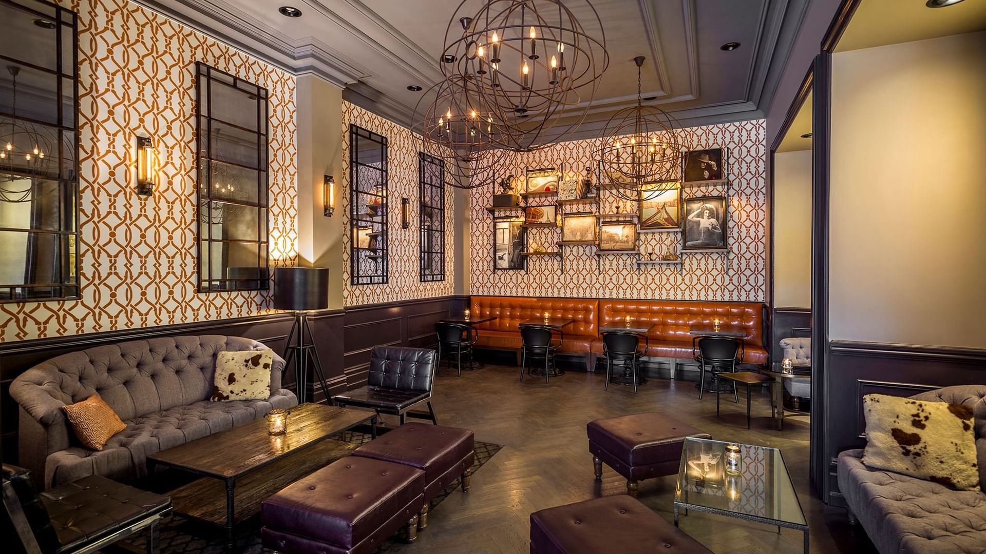 Leather benches by purple ottomans and globe lights surrounding the floor in The European at Warwick San Francisco