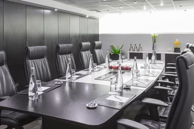 Table set-up with water bottles and fresh apples in the Boardroom at Hotel Los Delfines & Casino
