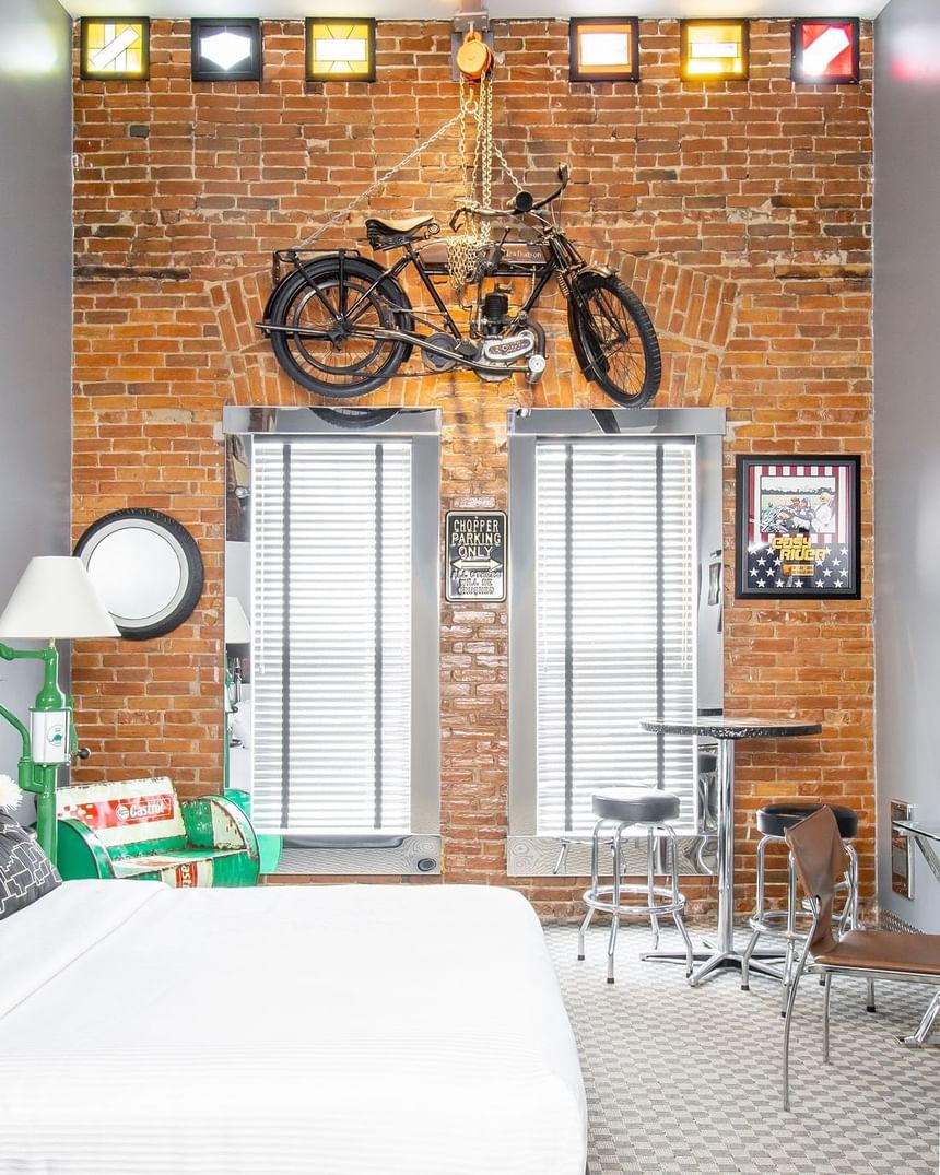 harley davidson motor cycle hanging above with queen bed 