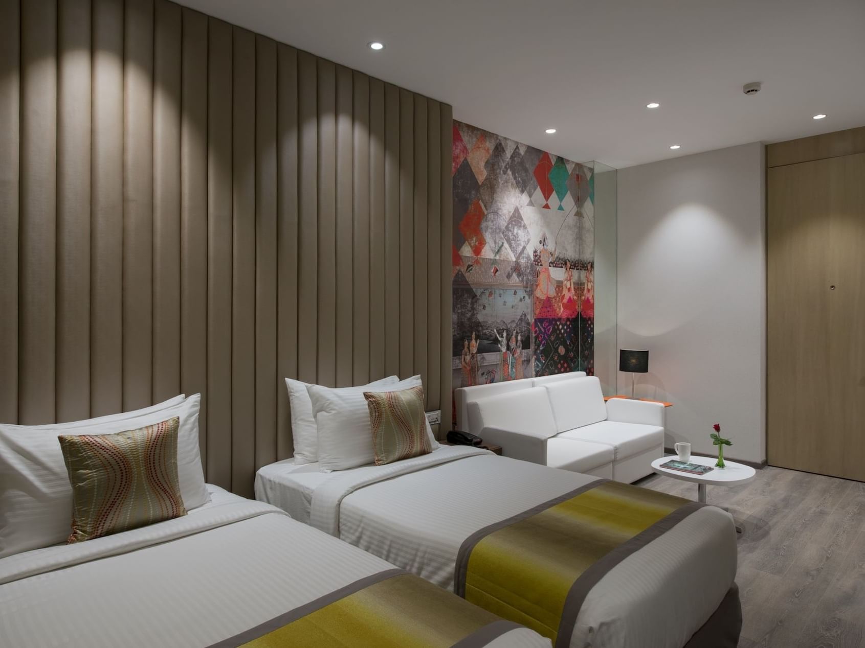 Two beds and a sofa in Studio Twin Room at Eastin Hotels