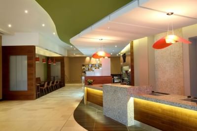 Lobby with reception desk, pendant lights and seating area at MARINN PLACE Financial District