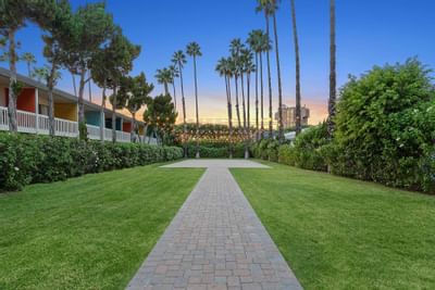 A walkway heading towards The Veranda in The Anaheim Hotel