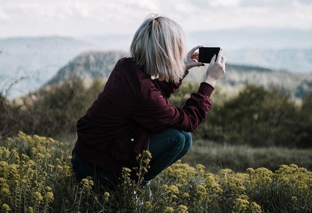 girl taking a photo in crouched position