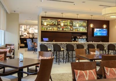 bar with chairs and dining tables
