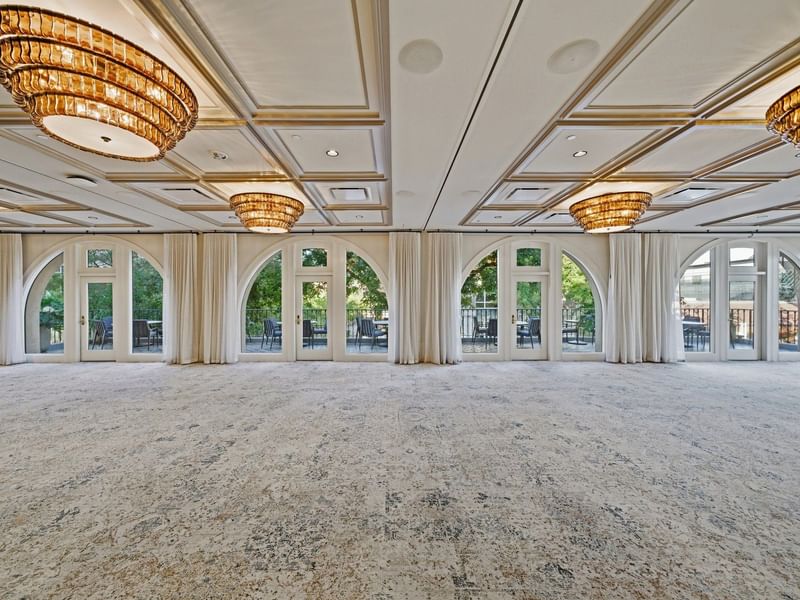Empty La Terraza Ballroom with elegant decor and large windows at el PRADO Hotel in Palo Alto.