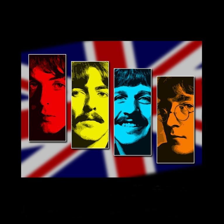 Four Beatles members in front of British Flag