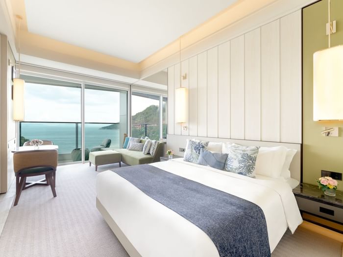 Comfy bed and lounge in Balcony Oceanfront Room at Fullerton Ocean Park Hotel Hong Kong
