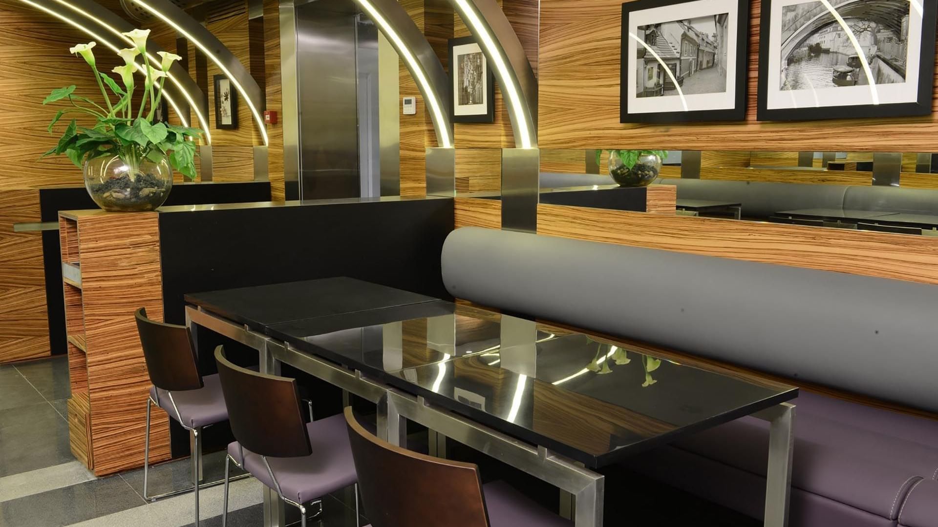 Modern booth seating with glass table and wooden walls at Ococo Restaurant in Warwick Stone 55 Beirut