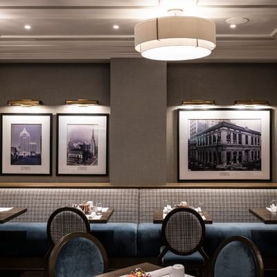Dining area with vintage photographs in The Bar and Grill at The St. Regis Hotel Vancouver