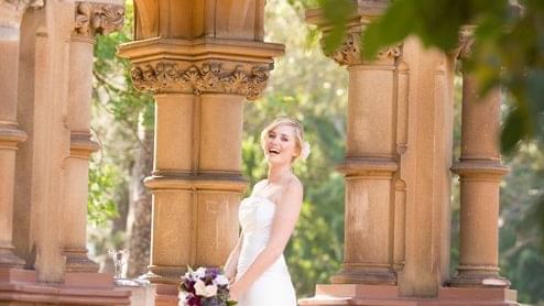 A bride is smiling and poses for a photo at Pullman Sydney Hyde
