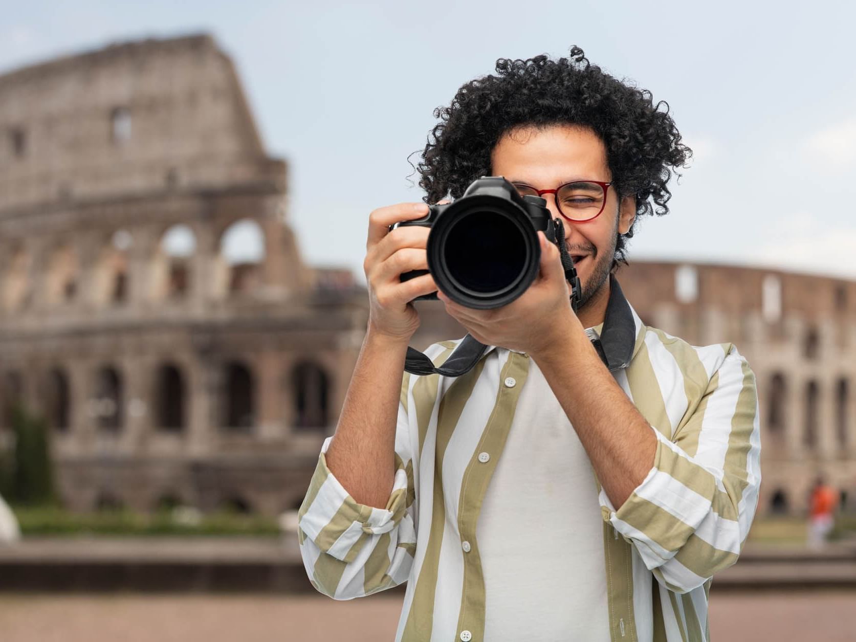 Man holding the camera to his face with a colosseum backdrop near The Independent