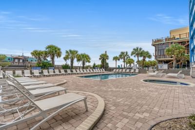 Sun beds arranged by the outdoor swimming pool at The Yachtsman Resort