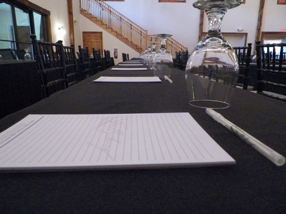 Close photo of conference table with paper and pen.