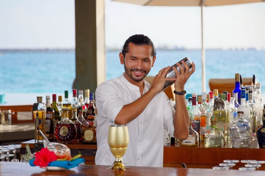 Bartender shaking a cocktail in Breeze Poolside Dining & Bar at Grand Park Kodhipparu, Maldives