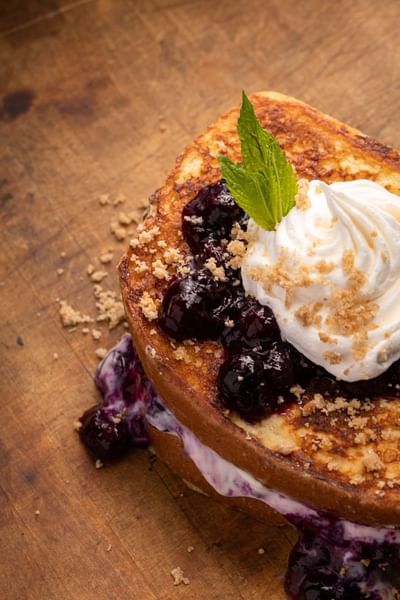 Gourmet blueberry French toast topped with whipped cream and crushed graham crackers at The Boulevard Inn & Bistro