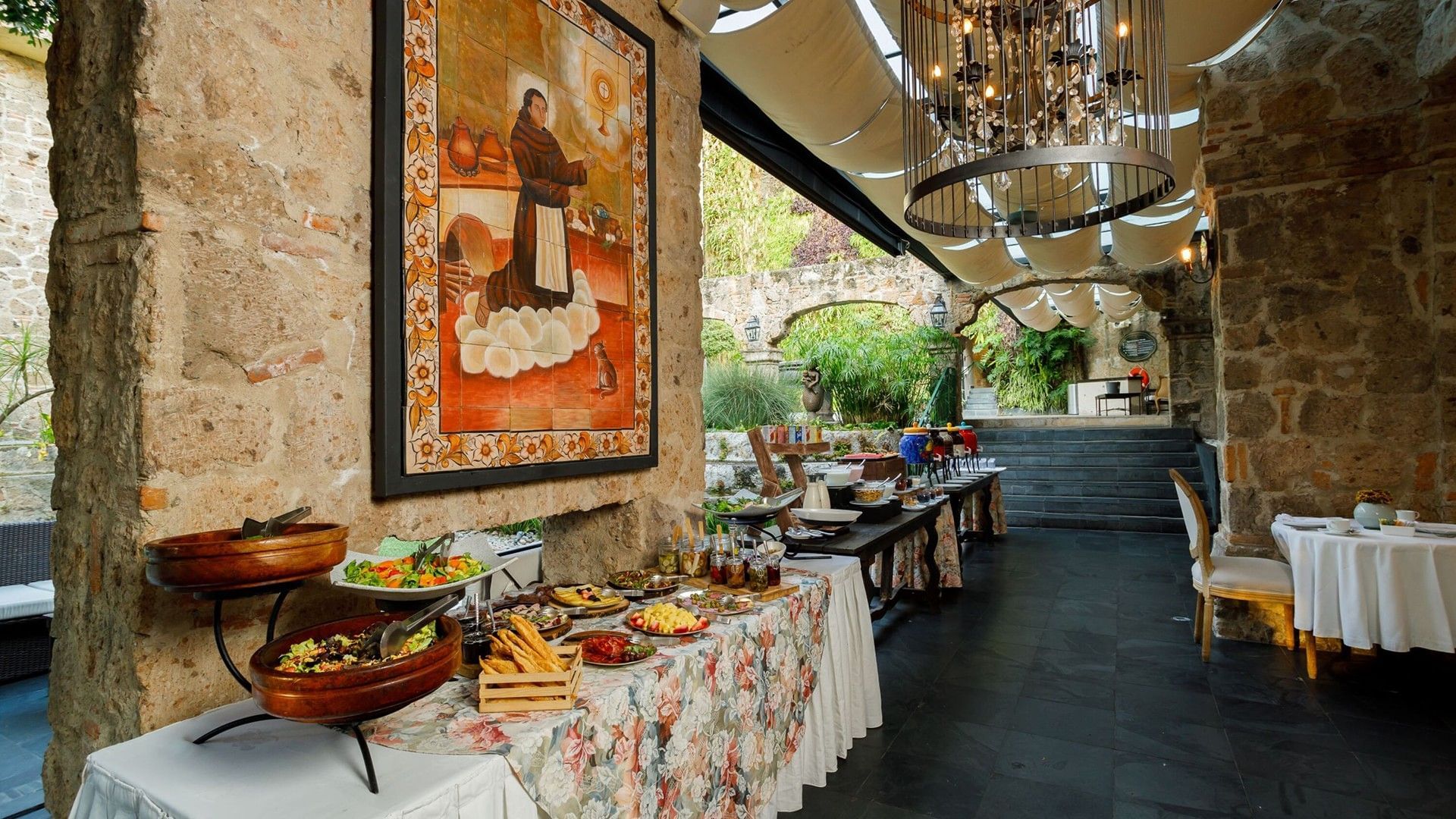 Tierra Mia restaurant buffet featuring fresh salads and religious tile art near the garden at Quinta Real Guadalajara