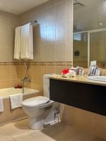 Suite bathroom with bathtub, toilet, and sink at The Naviti Resort in Korolevu.