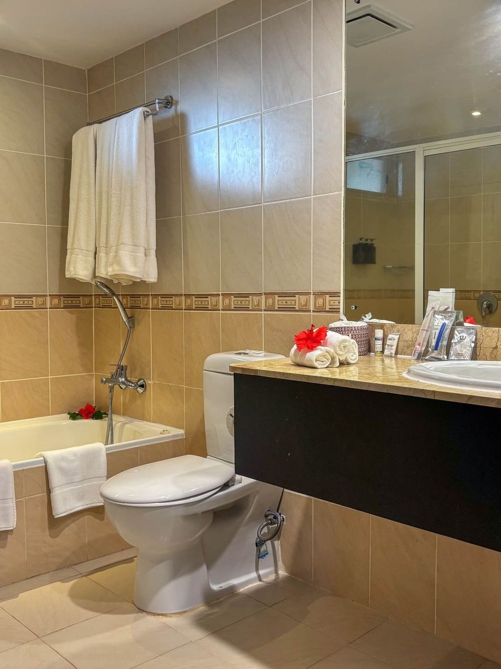 Suite bathroom with bathtub, toilet, and sink at The Naviti Resort in Korolevu.