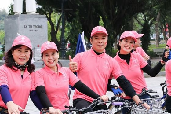 Foreigners wearing pink clothes & cycling near Hanoi Daewoo Hotel