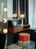 Elegant Deluxe King Room featuring a vanity table with a table lamp at The Capital Hotel, Apartments & Townhouse