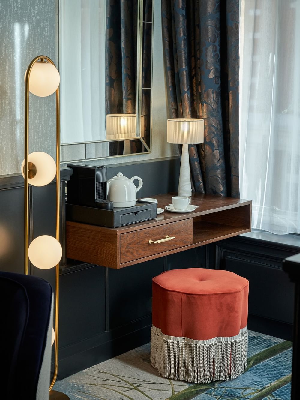 Elegant Deluxe Room featuring a vanity table with a table lamp at The Capital Hotel, Apartments & Townhouse