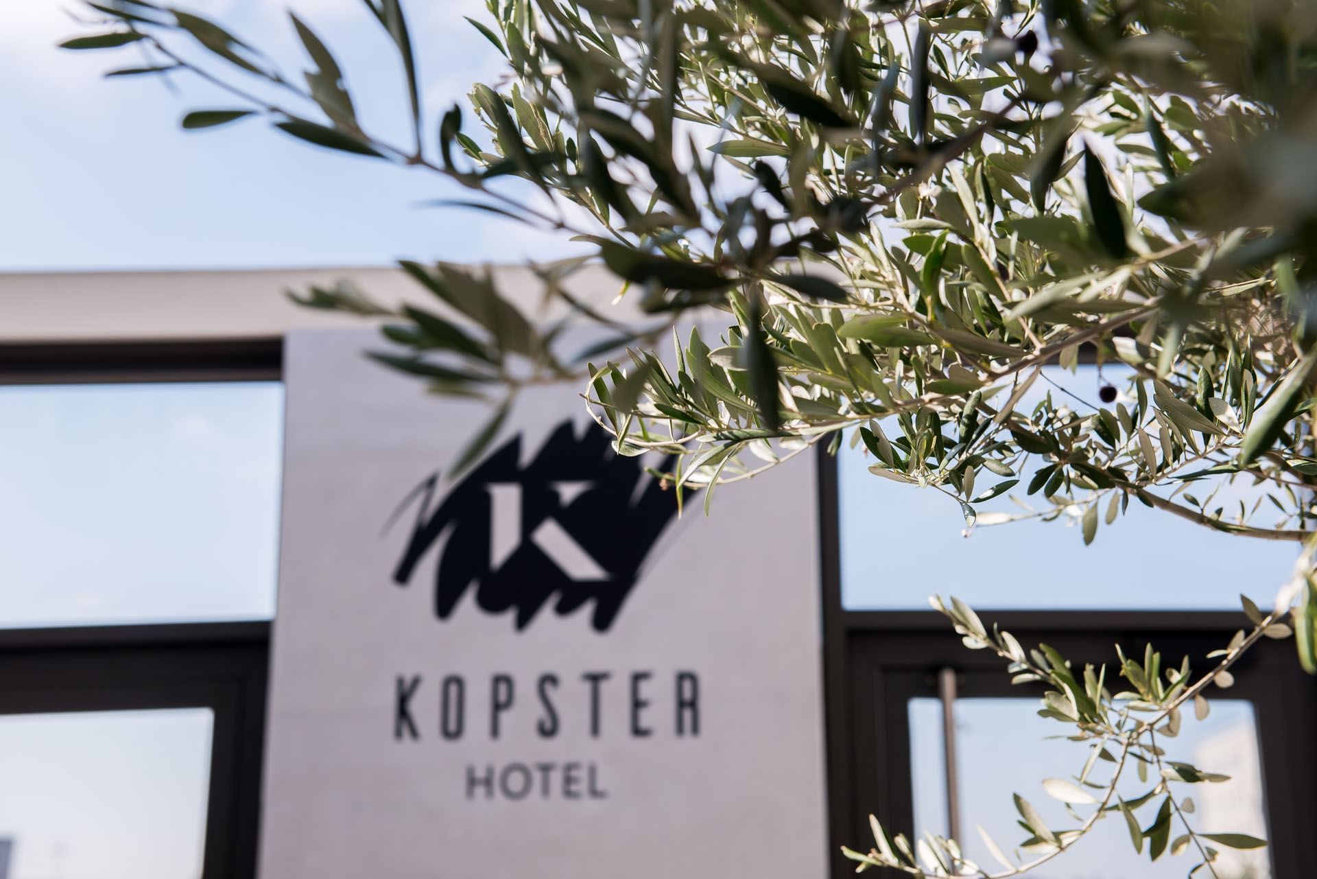 Kopster sign on a wall at Kopster Hotel Lyon Groupama Stadium