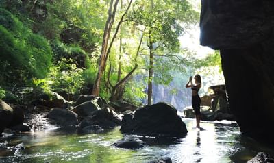 Lady doing yoga by the river at Hotel Rio Perdido