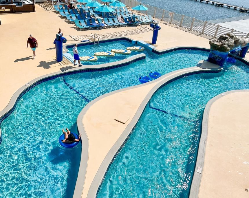Aerial view of guests enjoying the lazy river and pool  on a bright, sunny afternoon at Margaritaville Resort Biloxi