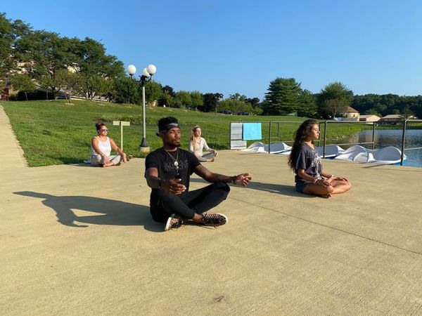 People meditating outside near Honor’s Haven