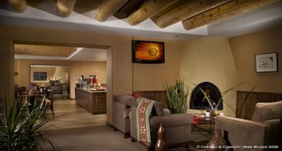Executive Lounge at Hilton Santa Fe Buffalo Thunder with a warm fireplace, comfy sofas, and stylish modern decor