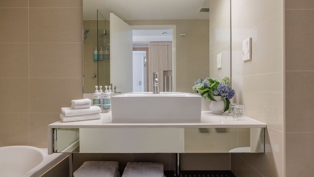 Bathroom vanity with mirror and amenities in Superior Room at Novotel Sydney Olympic Park